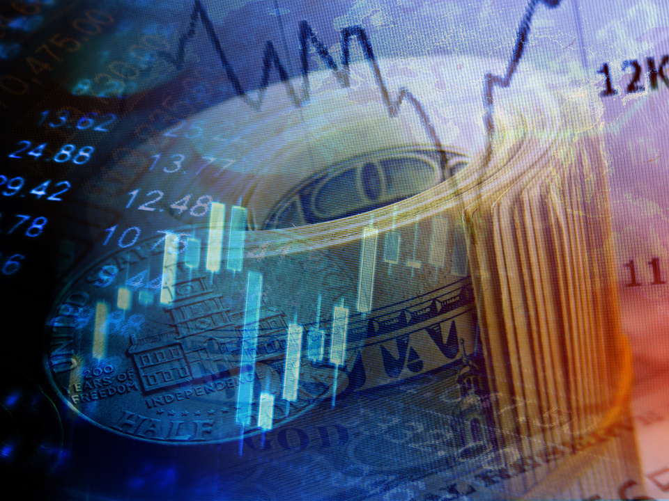 Market graph and rolled dollars.